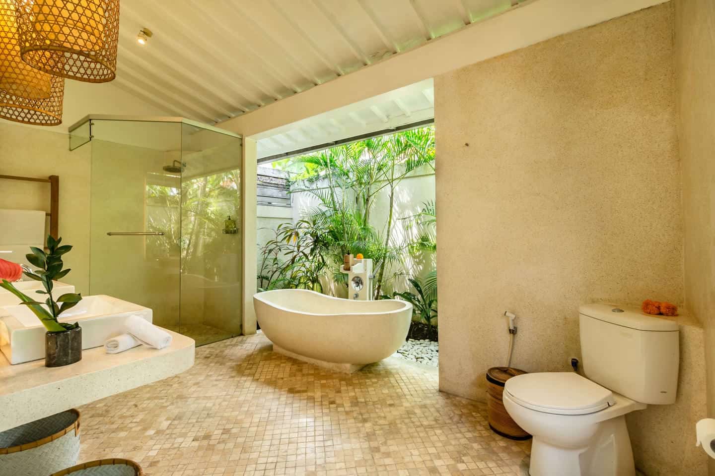 Luxurious bathroom with bathtub and outdoor plants.