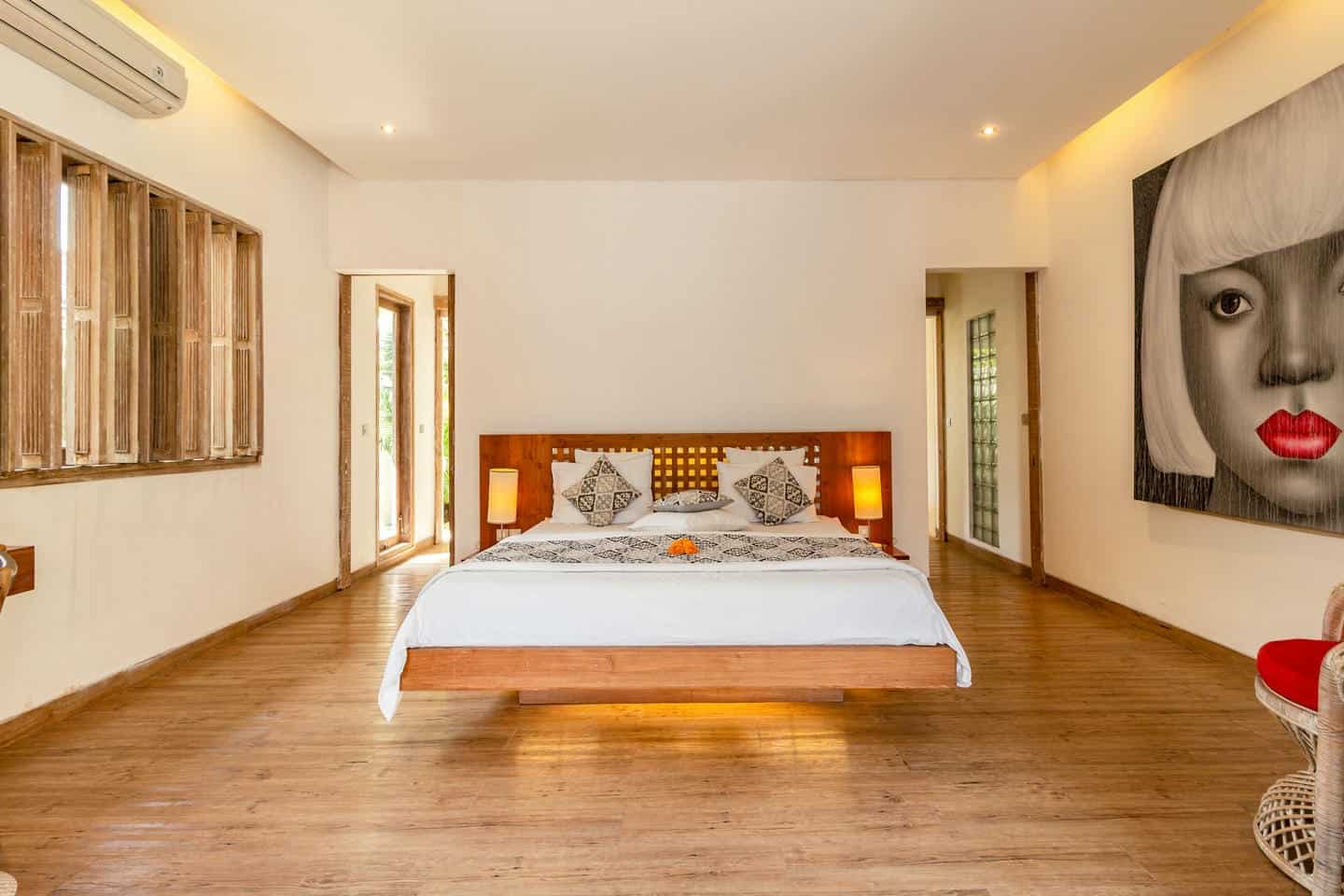 Spacious bedroom with modern decor and wooden flooring