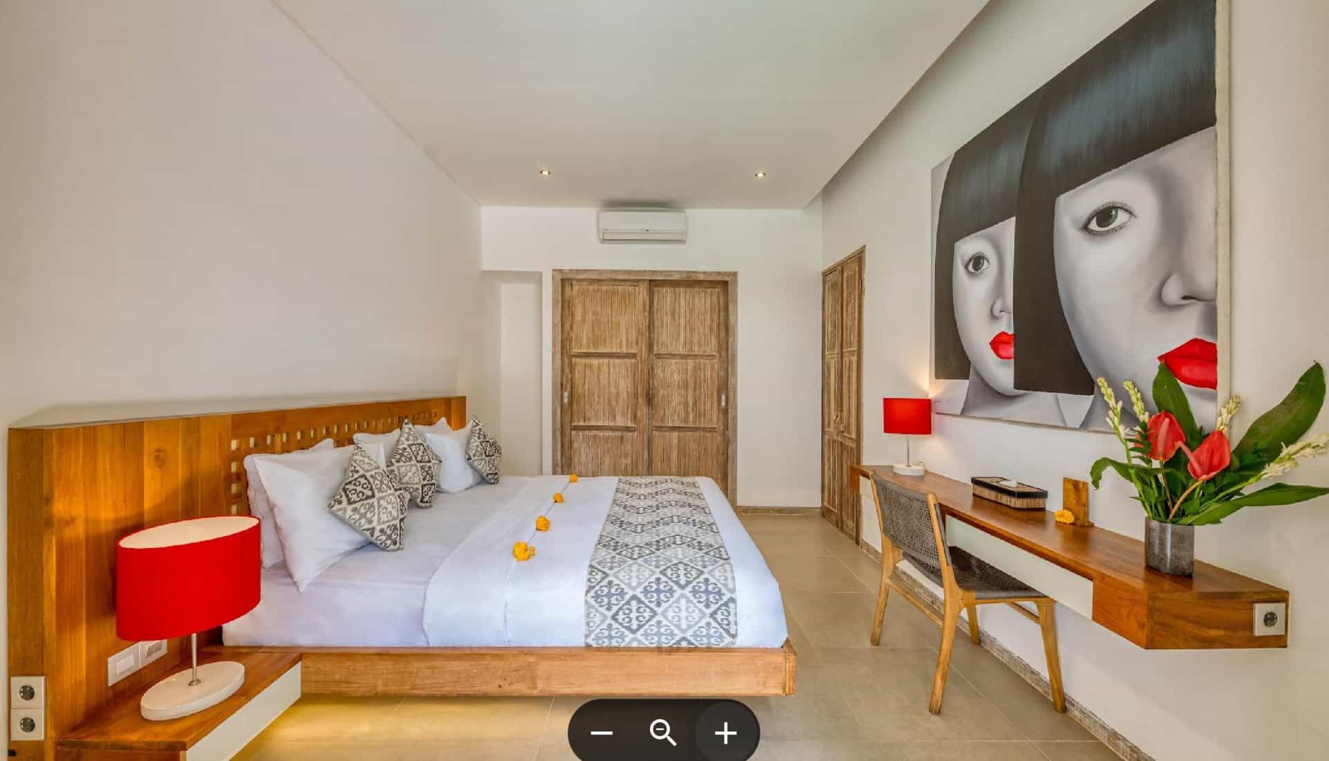Modern bedroom with wooden furniture and artwork decor.