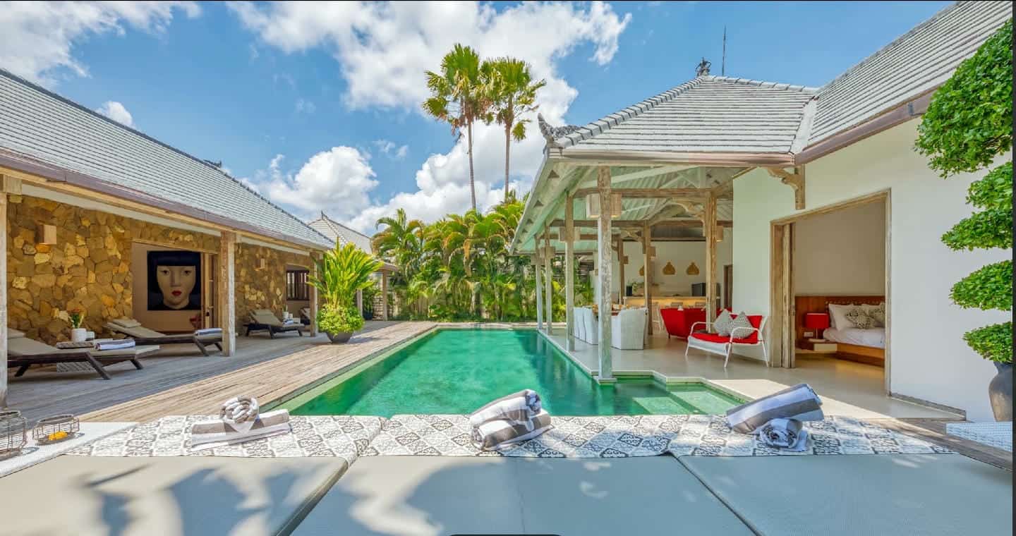 Luxury villa with pool and outdoor seating area.