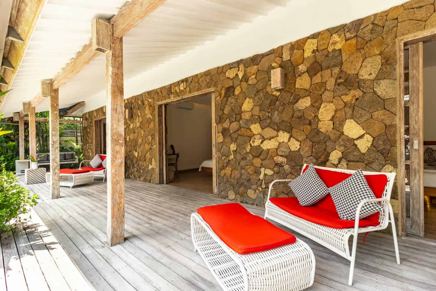Stone patio with red cushioned seating
