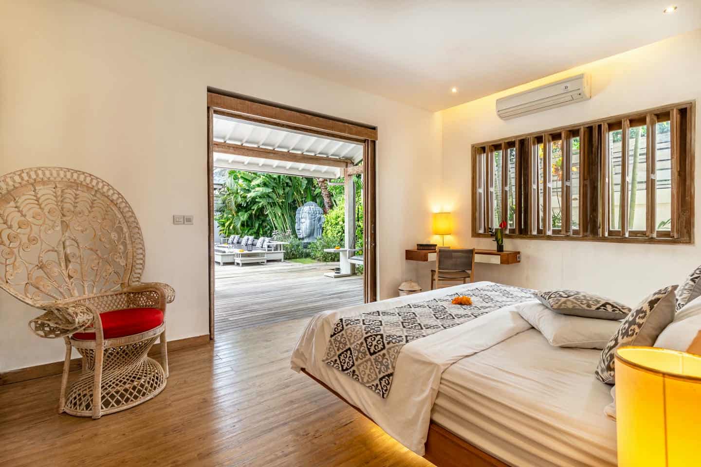 Bright bedroom with outdoor garden view.