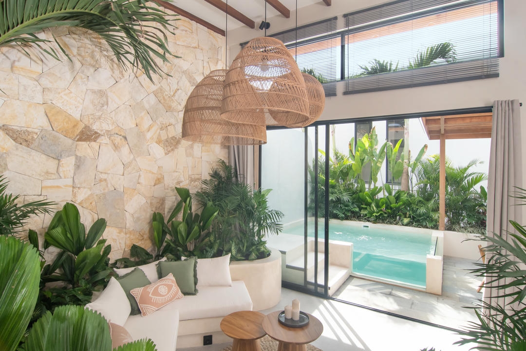 Modern living room with indoor plants and pool view.