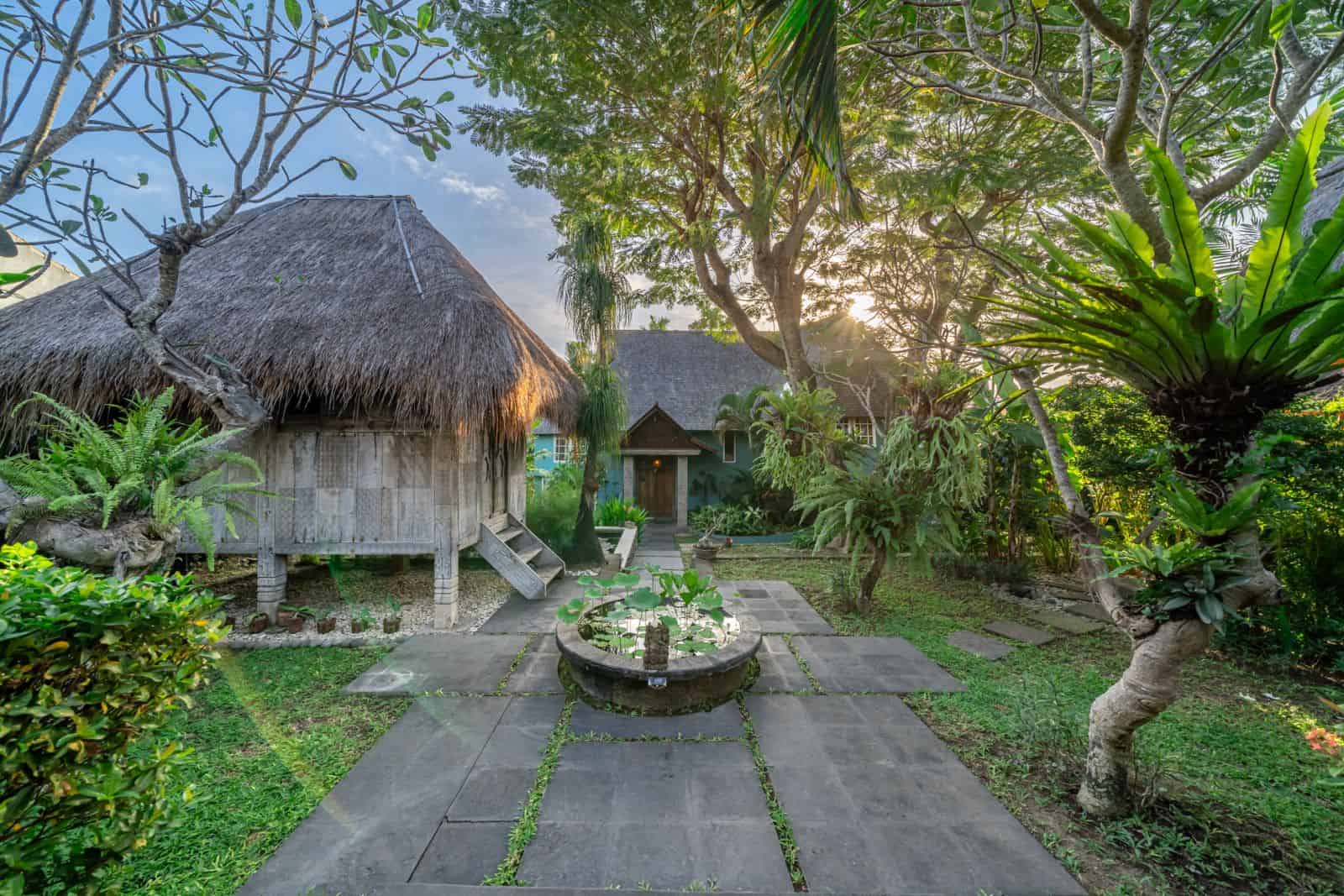 Peaceful garden with traditional thatched-roof huts