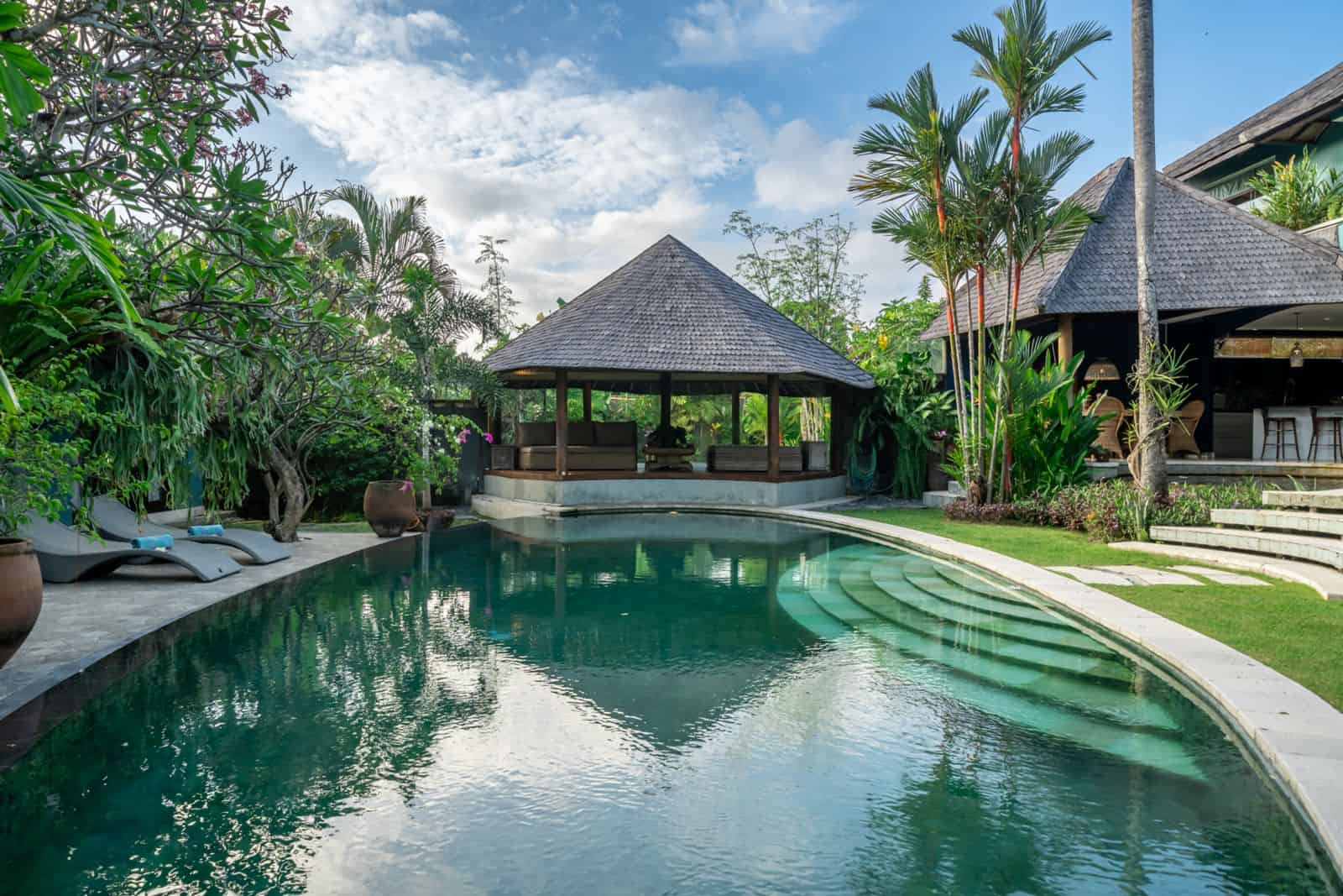 Tropical villa with pool and lush gardens.