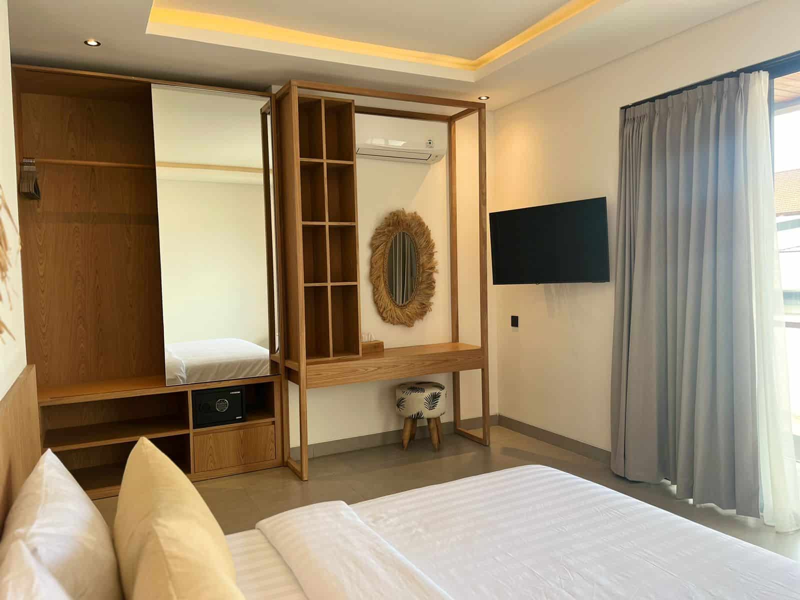 Modern hotel room with desk and TV