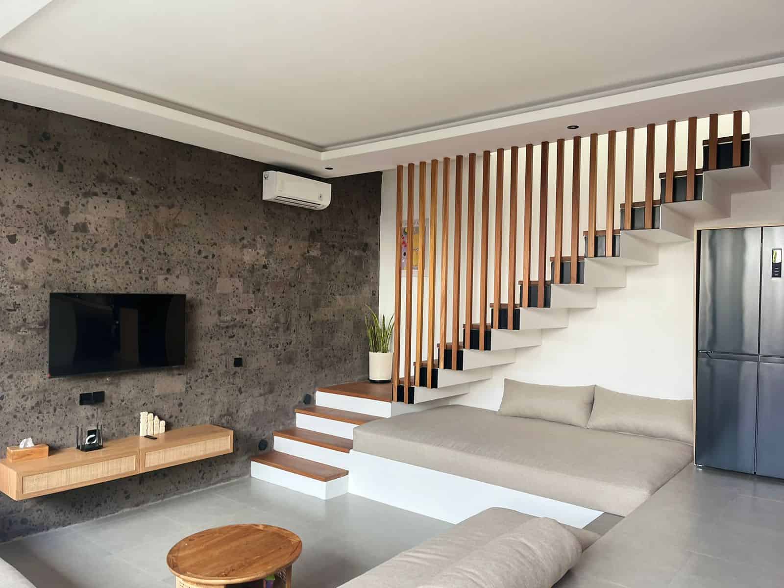 Modern living room with stairs and TV