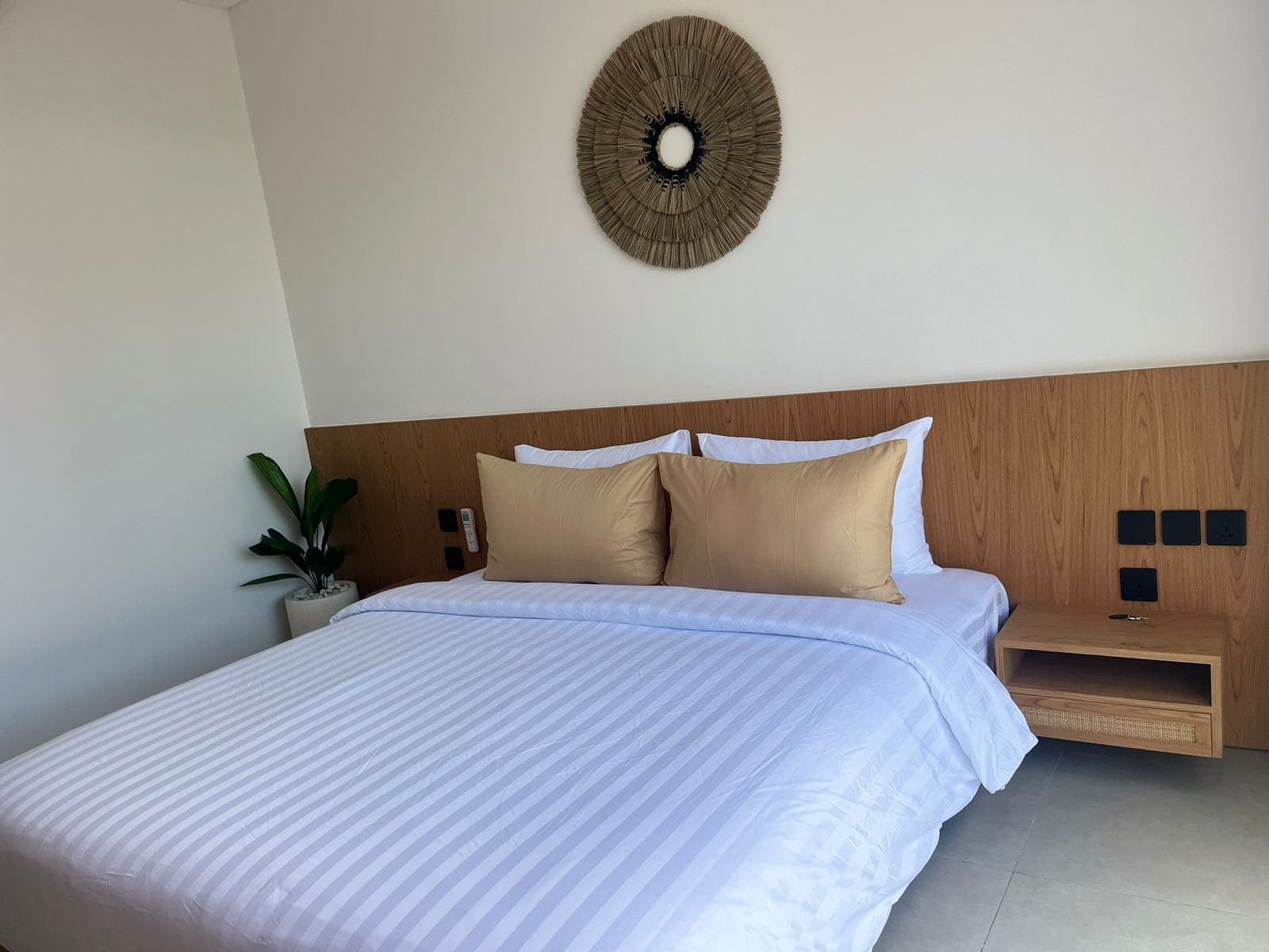 Modern bedroom with white bed and decor.