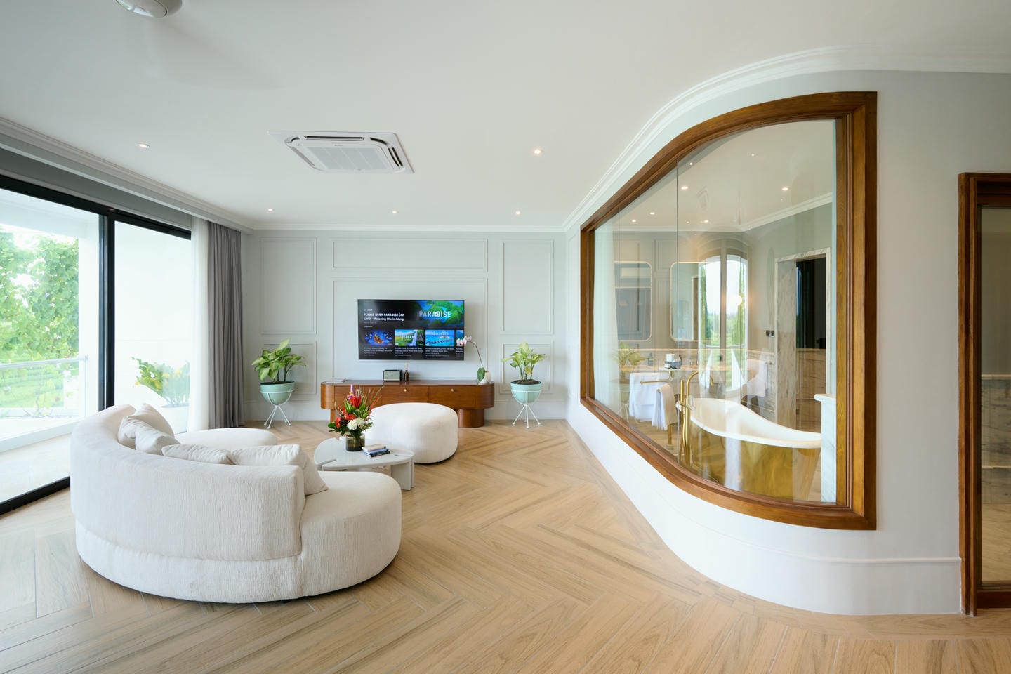 Modern living room with curved sofa and glass wall