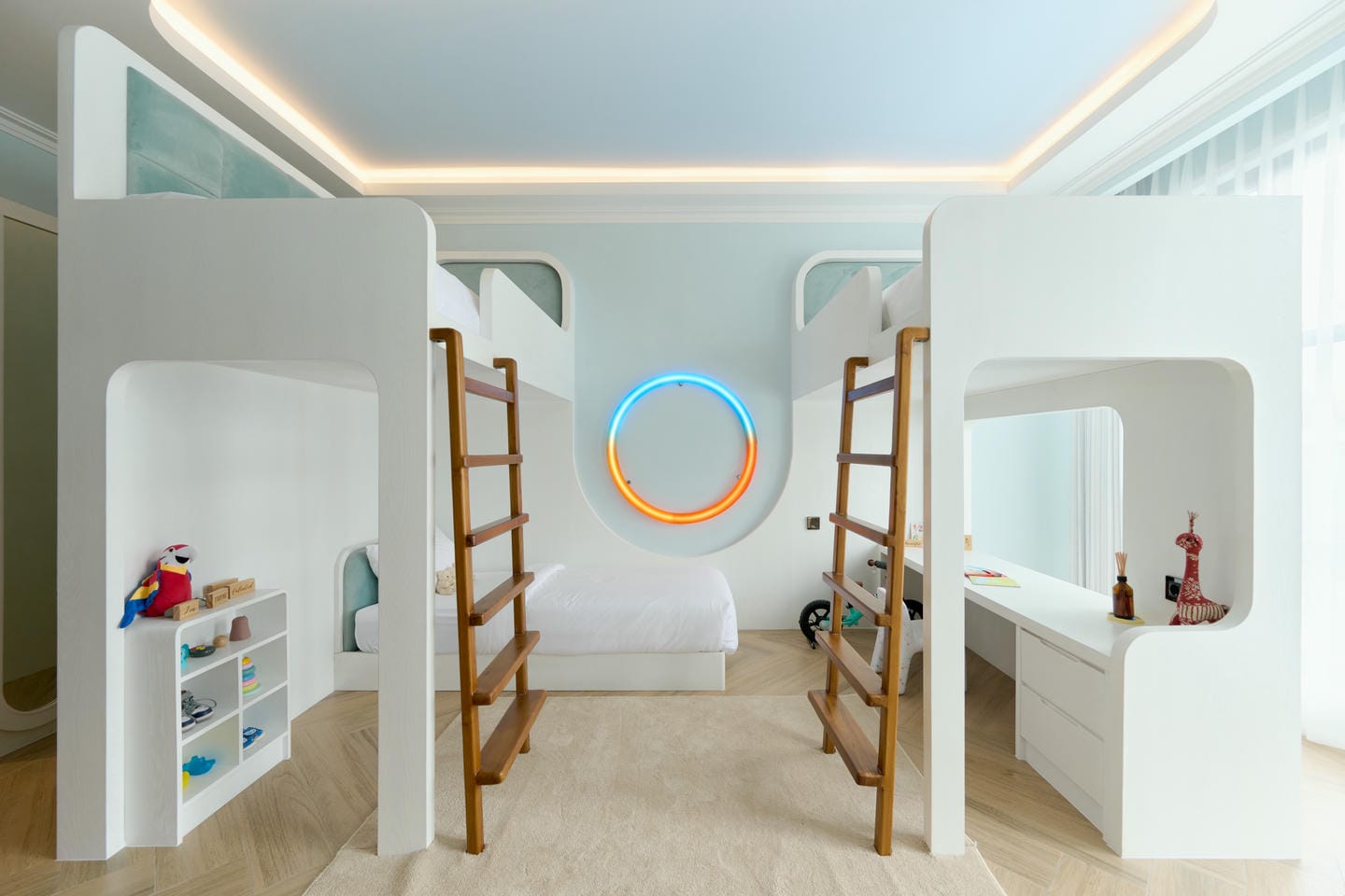 Modern loft bedroom with bunk beds and neon light.