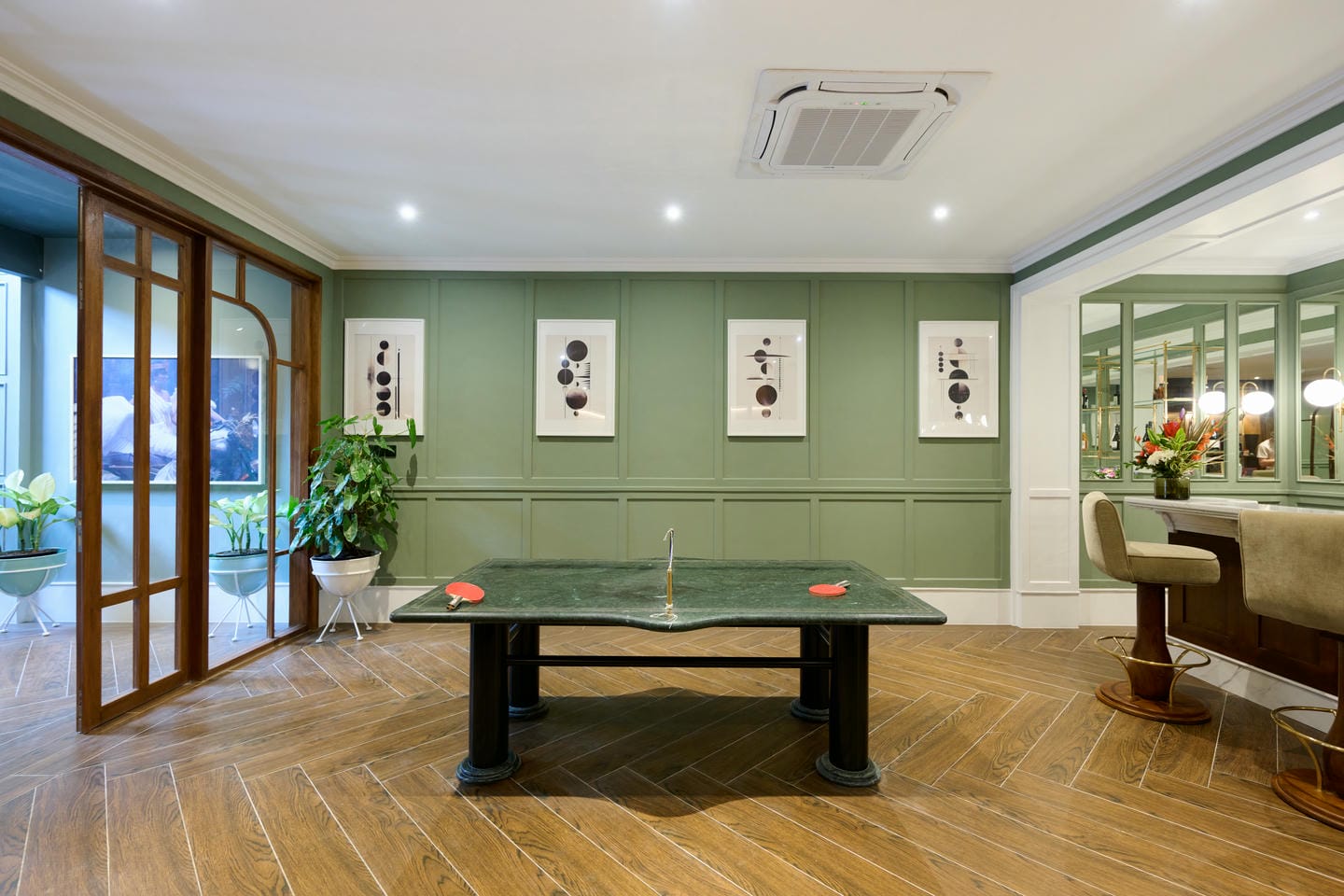 Modern game room with ping pong table and chairs.
