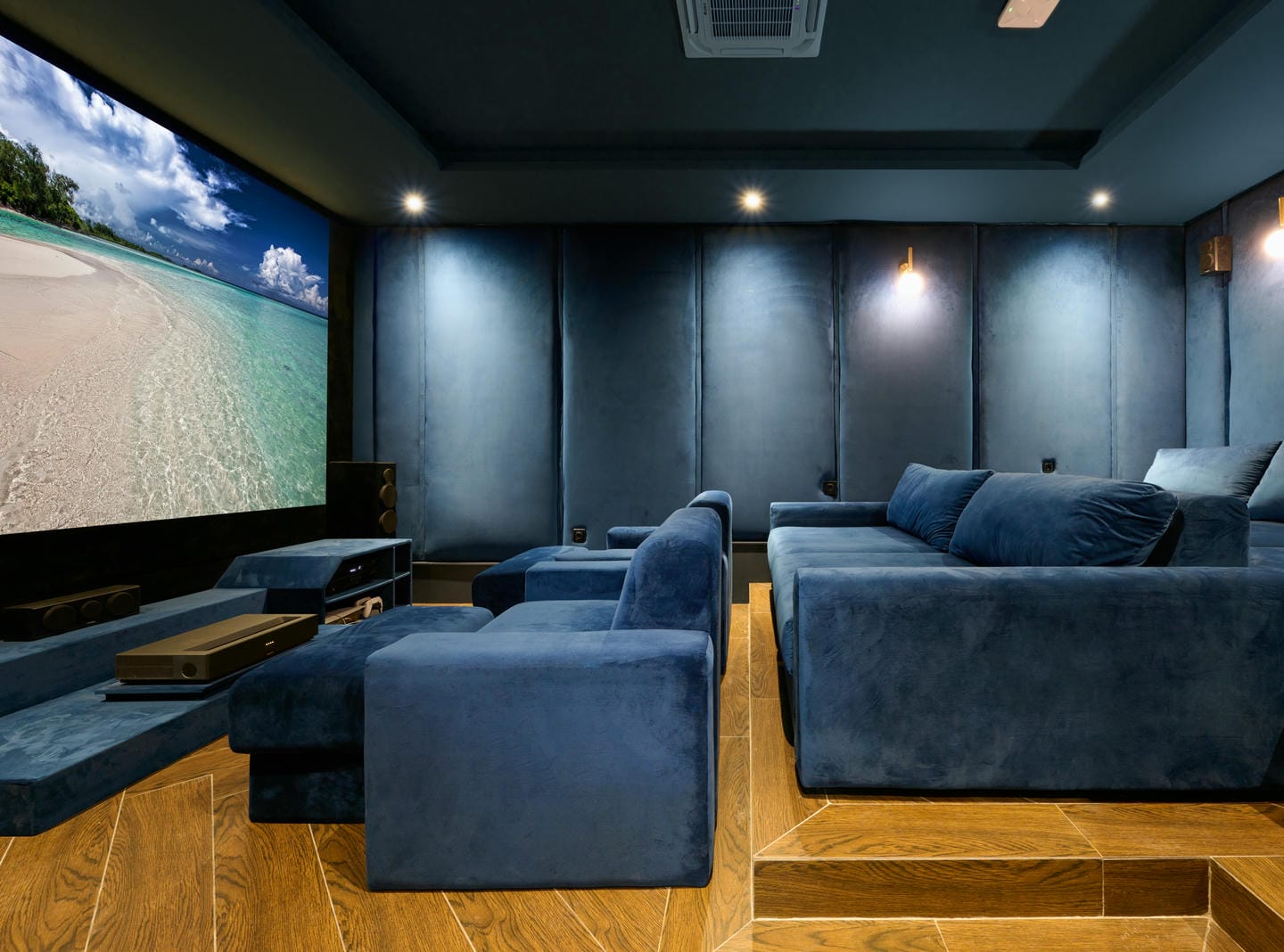 Luxury home theater with large screen and seating.