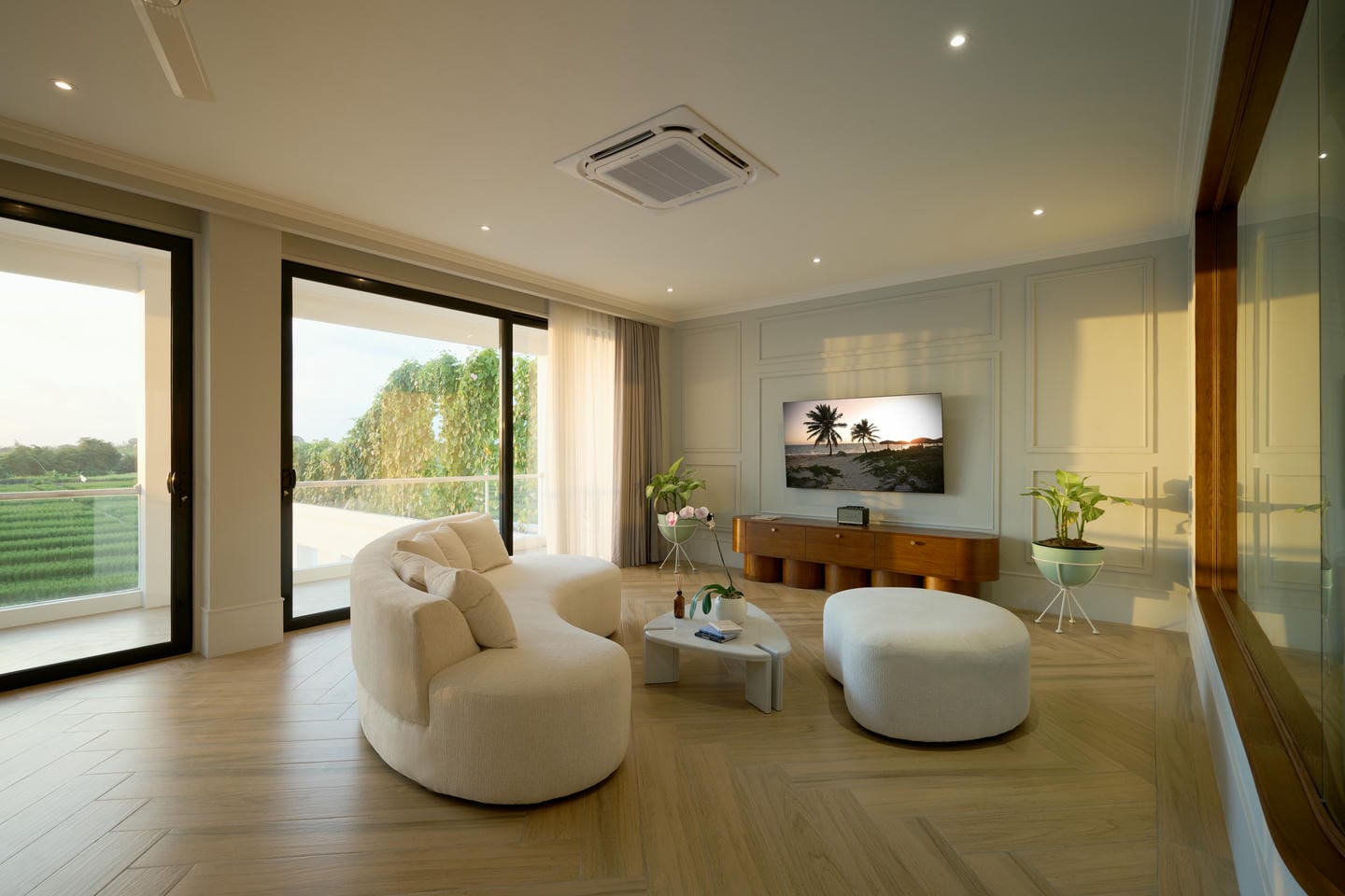 Modern living room with large windows and TV.