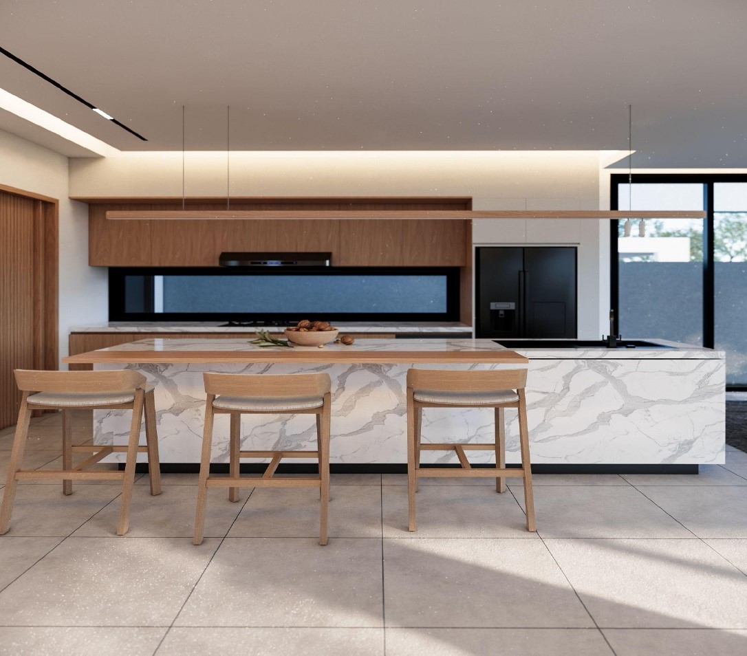 Modern kitchen with marble island and chairs.