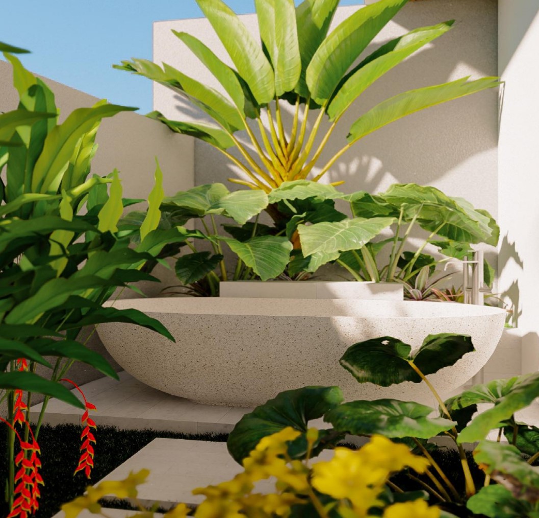 Modern outdoor stone bathtub with lush green plants.
