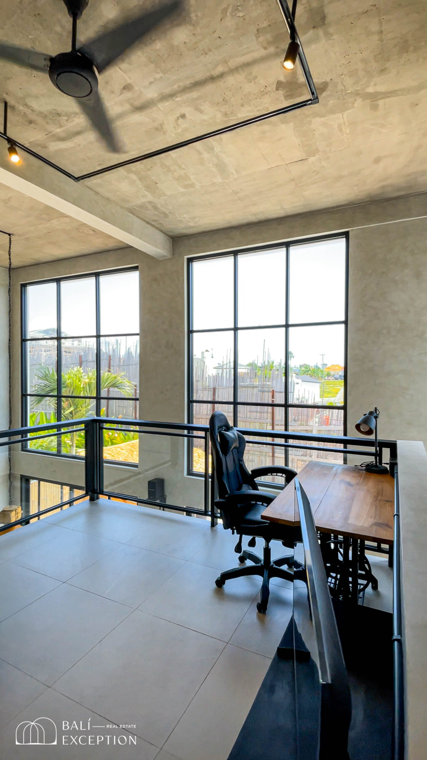 Loft office space with large windows.