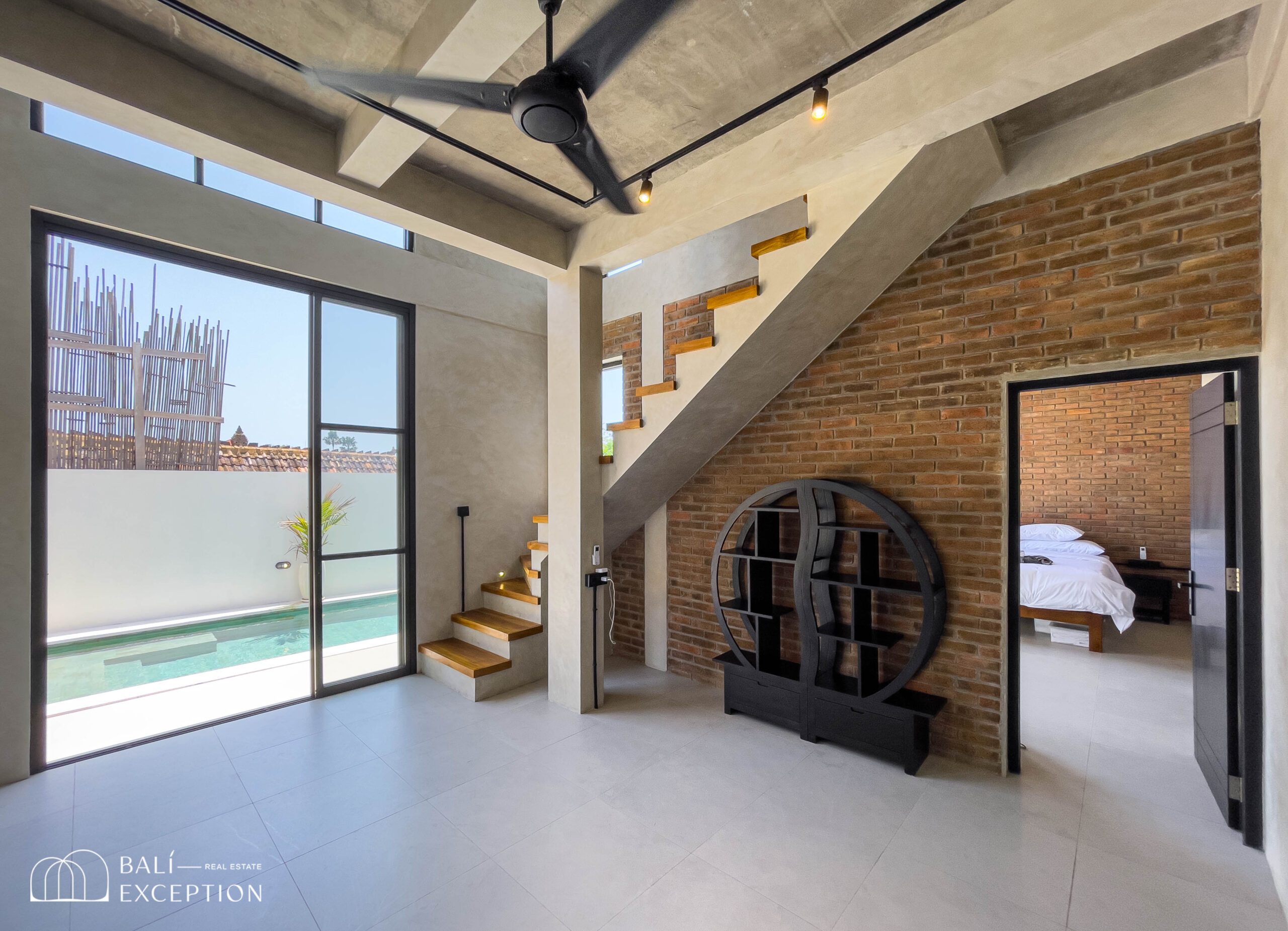 Modern loft interior with pool view and staircase