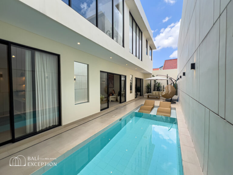 Modern villa with pool and outdoor seating area.