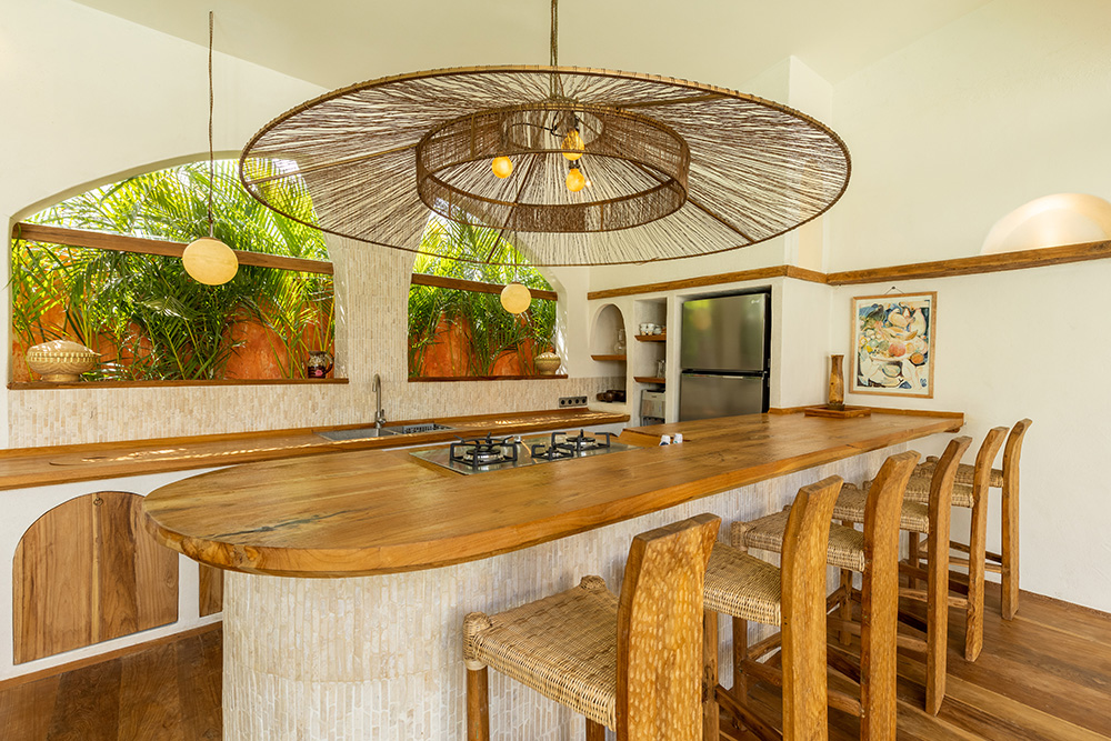 Modern kitchen with wooden island and woven decor.