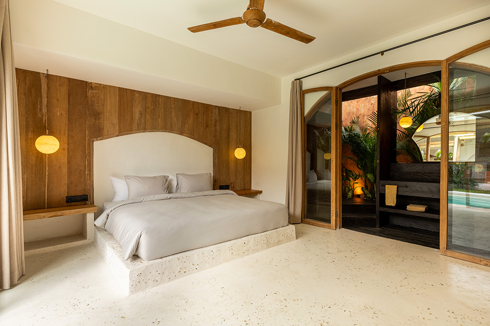 Luxury bedroom with wooden decor and pool view