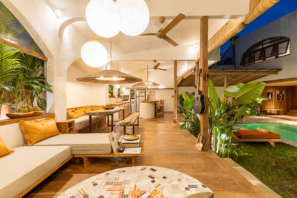 Modern tropical lounge with open seating and pool.