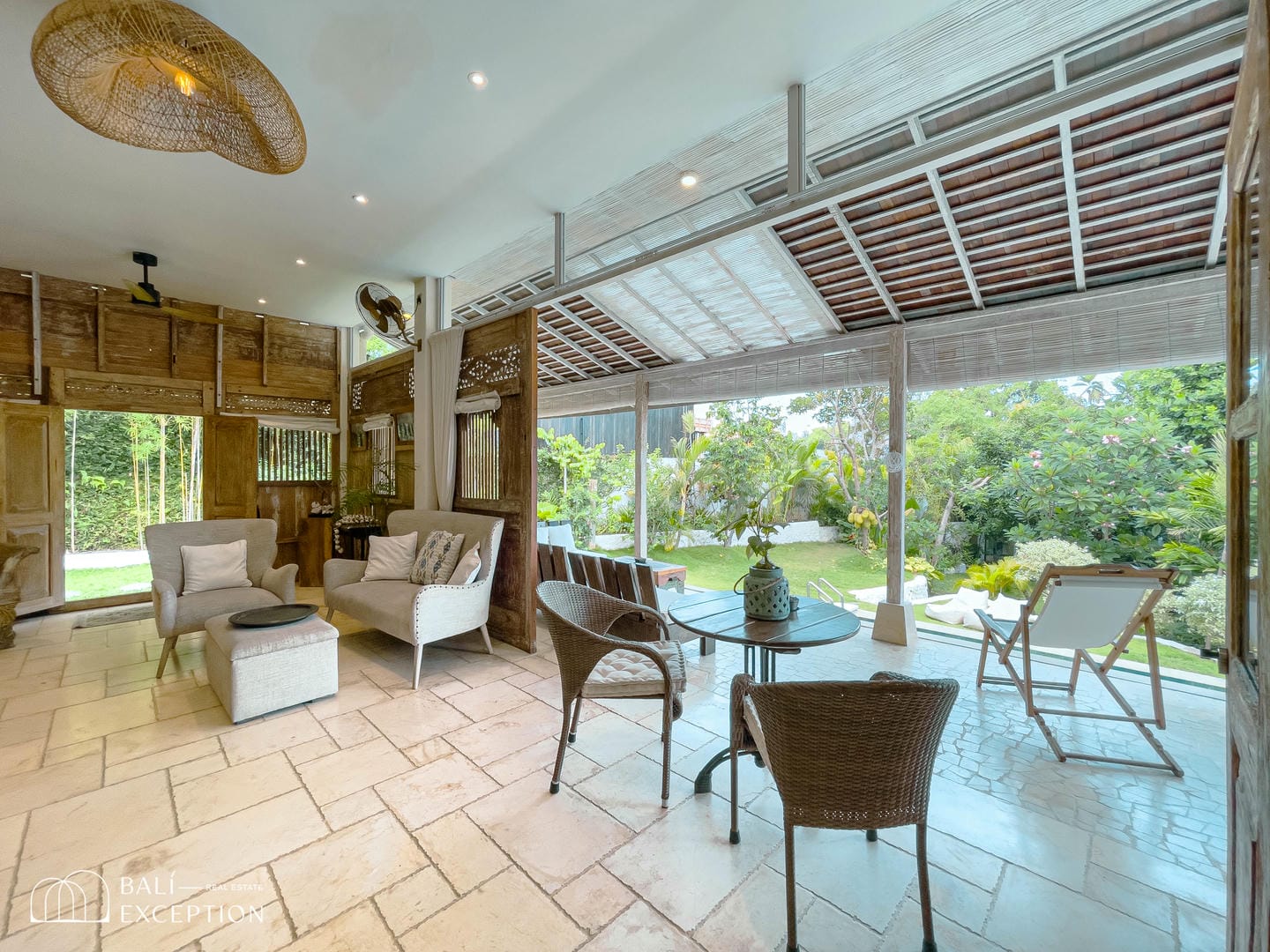 Cozy patio with garden view and seating area.