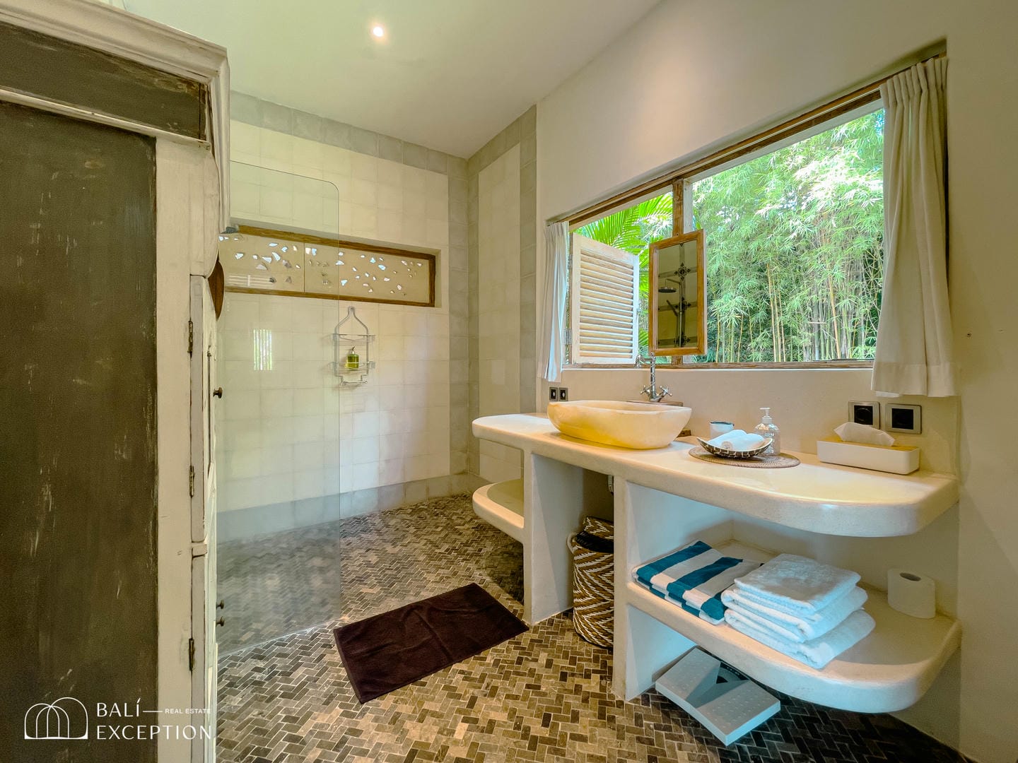 Modern bathroom with large window and stylish decor.