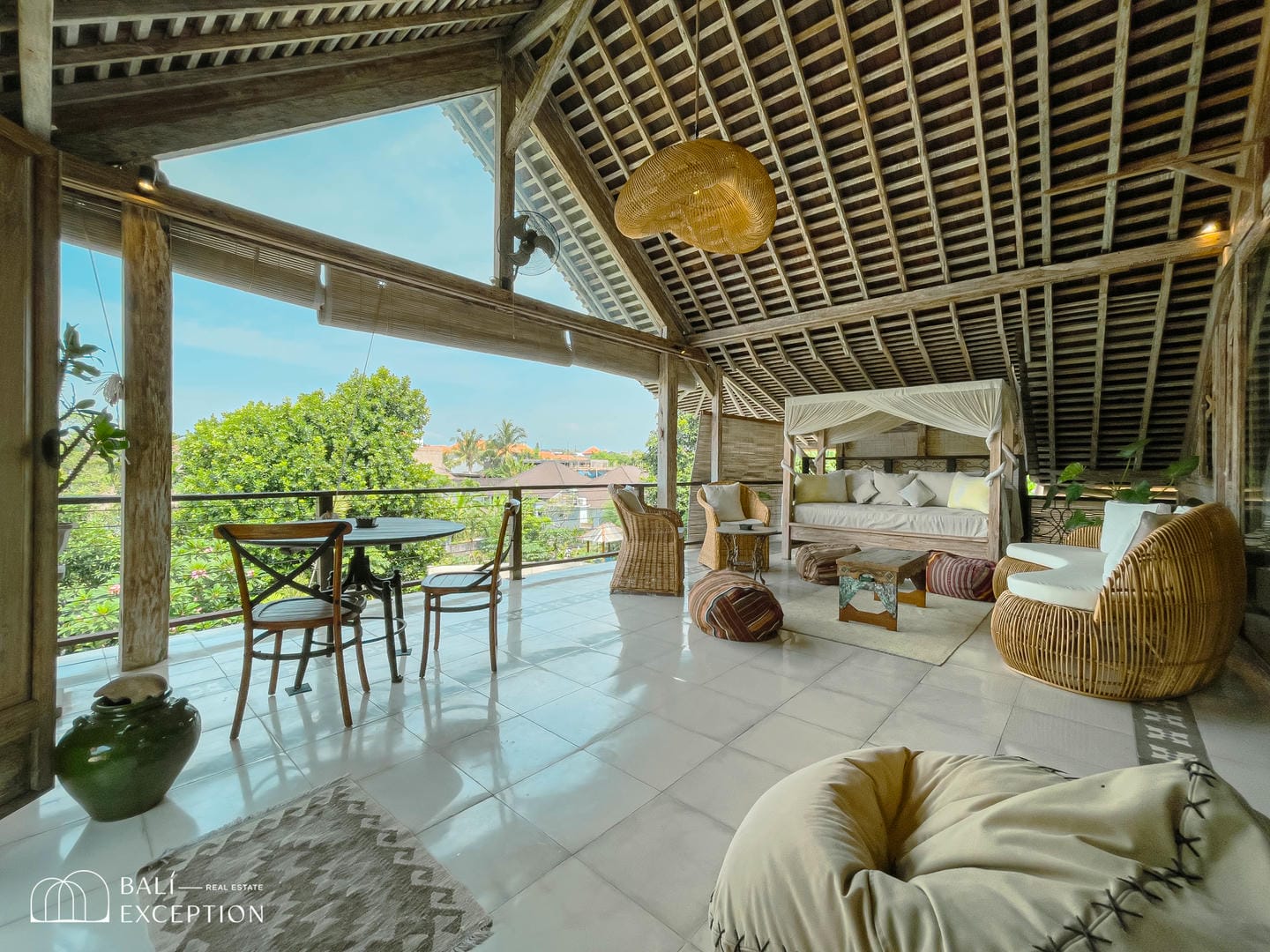 Cozy tropical patio with luxurious seating and views.
