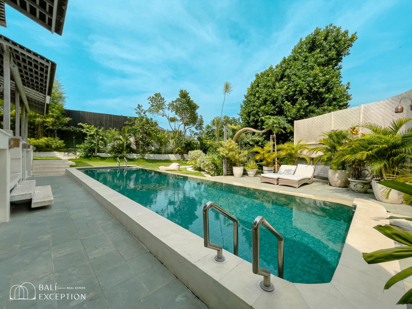 Luxurious outdoor pool with tropical landscaping.
