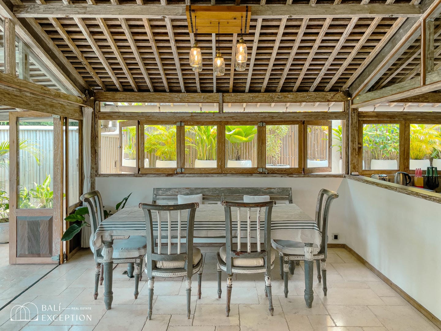 Rustic dining area with wooden table and chairs.
