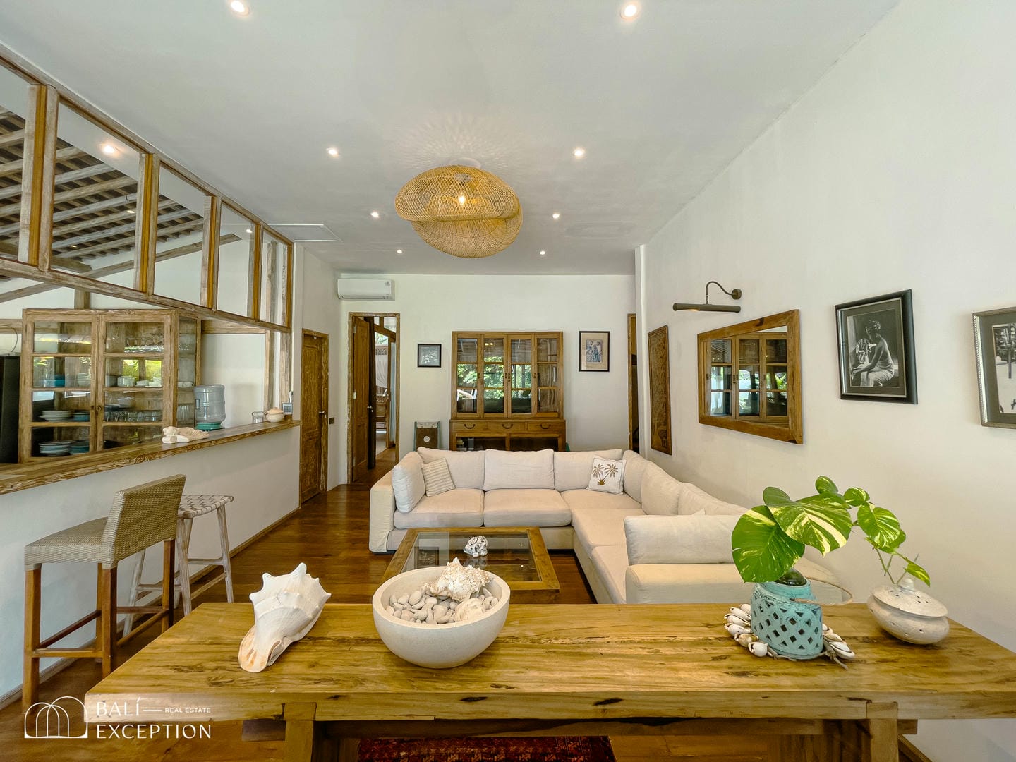Spacious living room with rustic decor and wooden furniture.