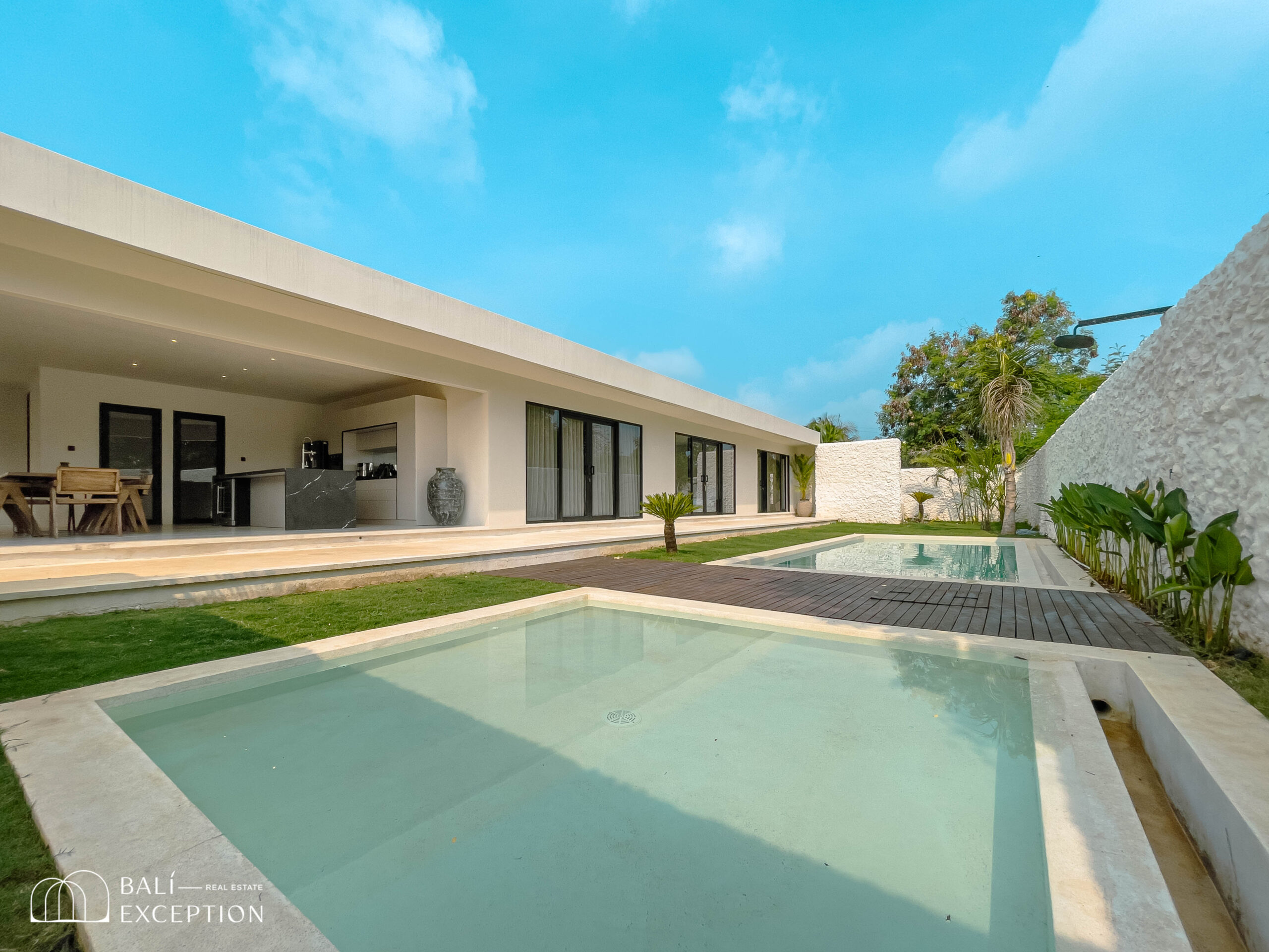 Modern villa with pool and garden view.
