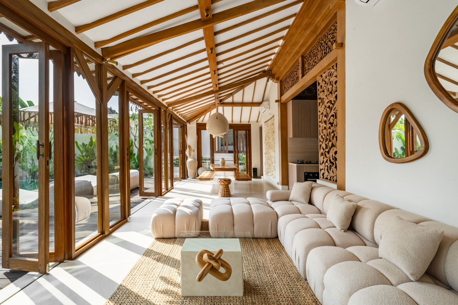 Spacious living room with natural wood accents and sunlight.