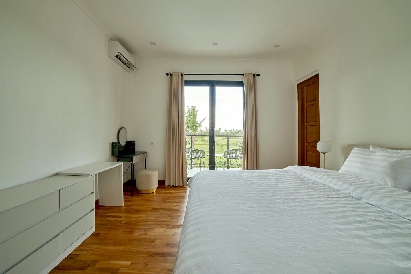 Bright bedroom with balcony and modern decor.