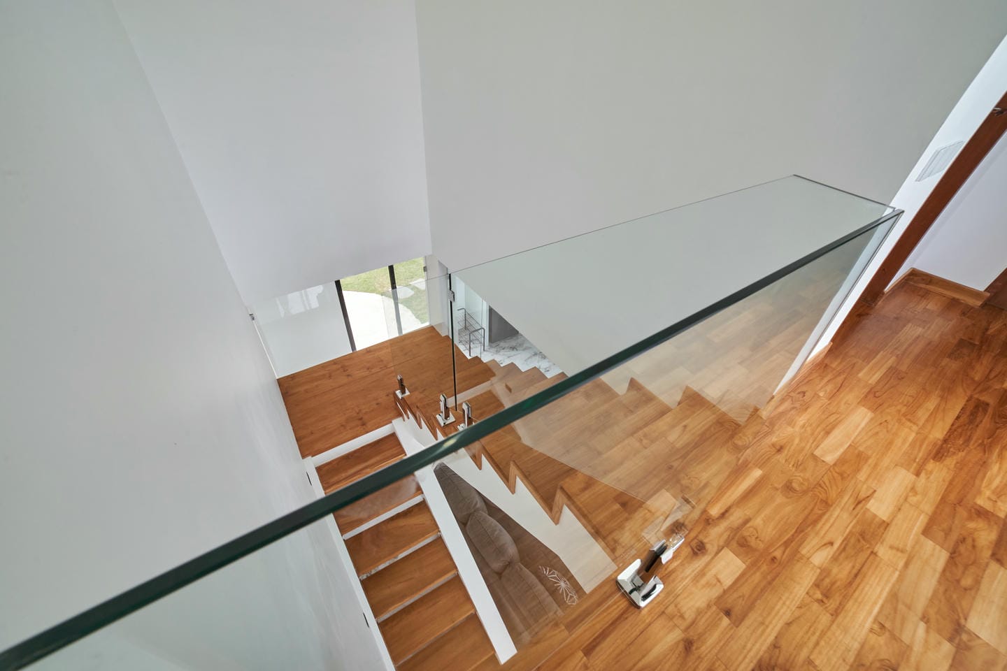 Modern wooden staircase with glass railing
