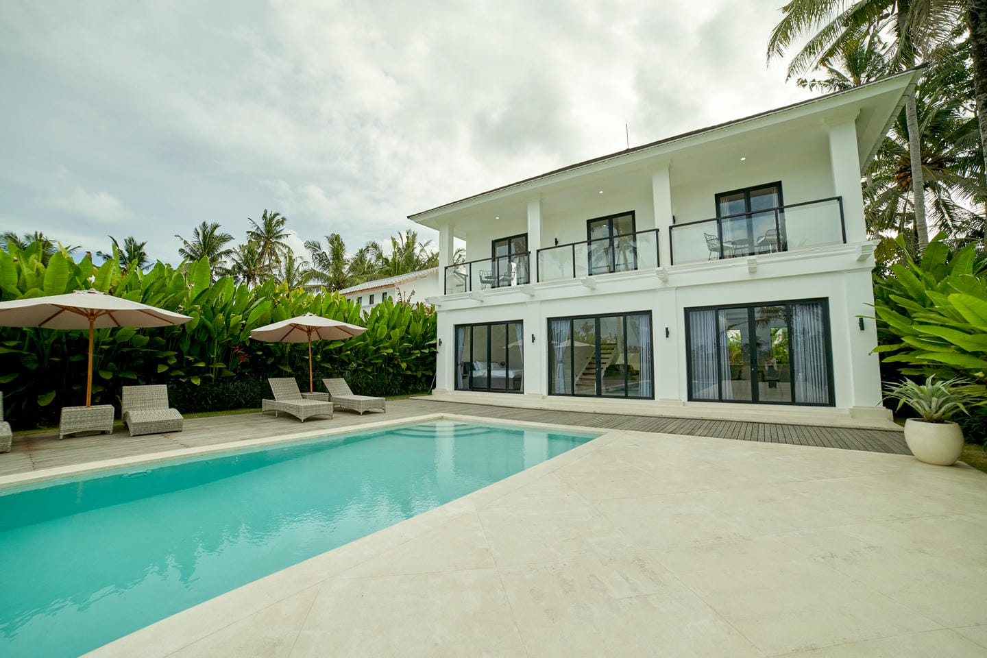 Luxurious villa with pool and tropical landscaping.