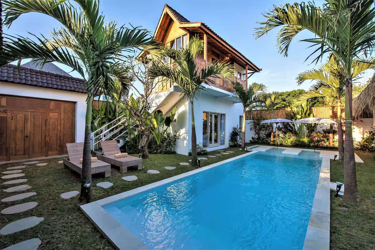 Tropical backyard with pool and palm trees