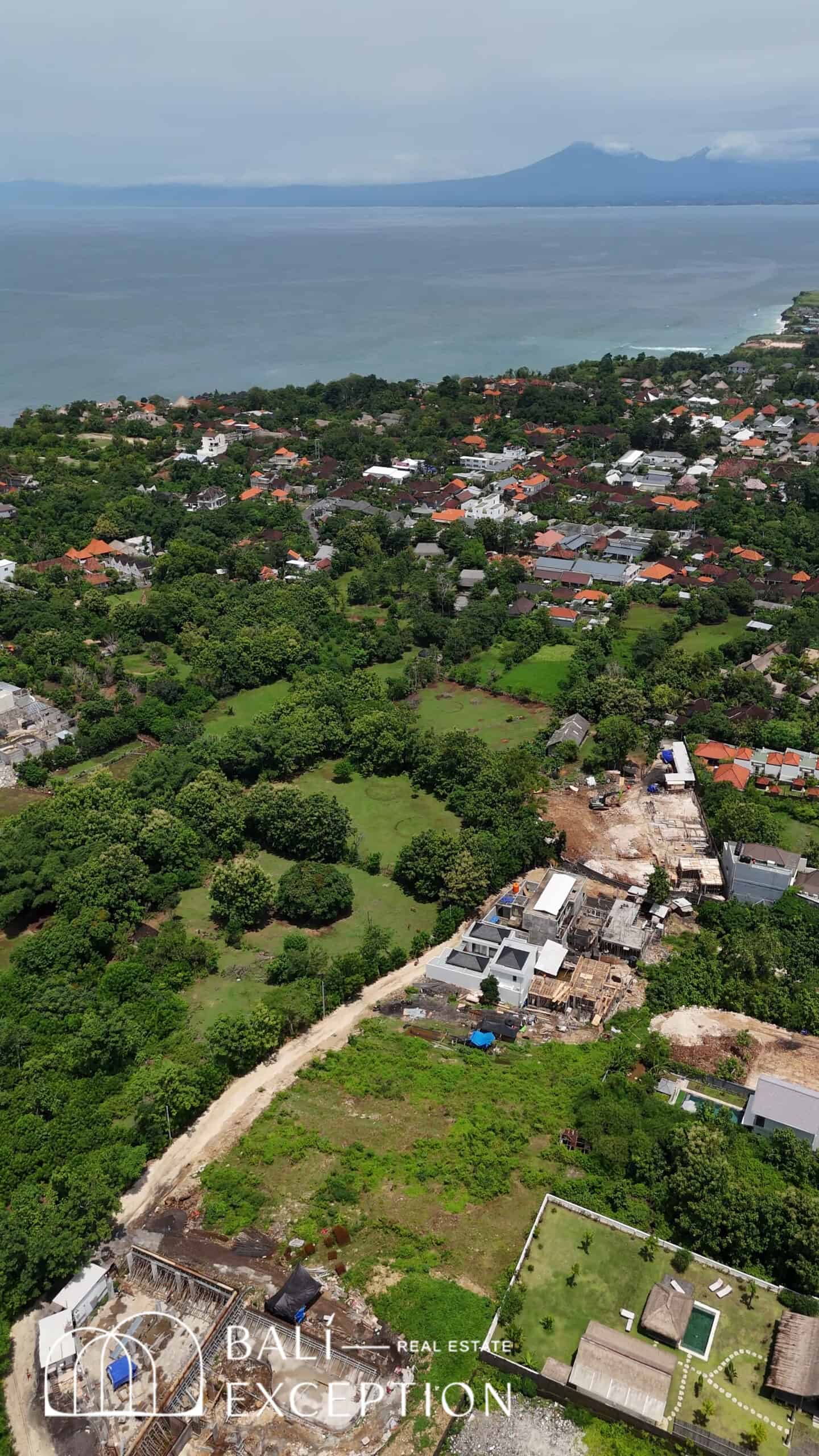 Aerial view of coastal town and lush greenery