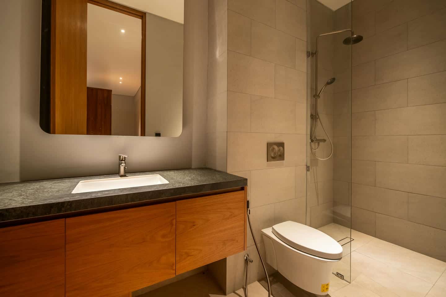 Modern bathroom with sink, toilet, and shower