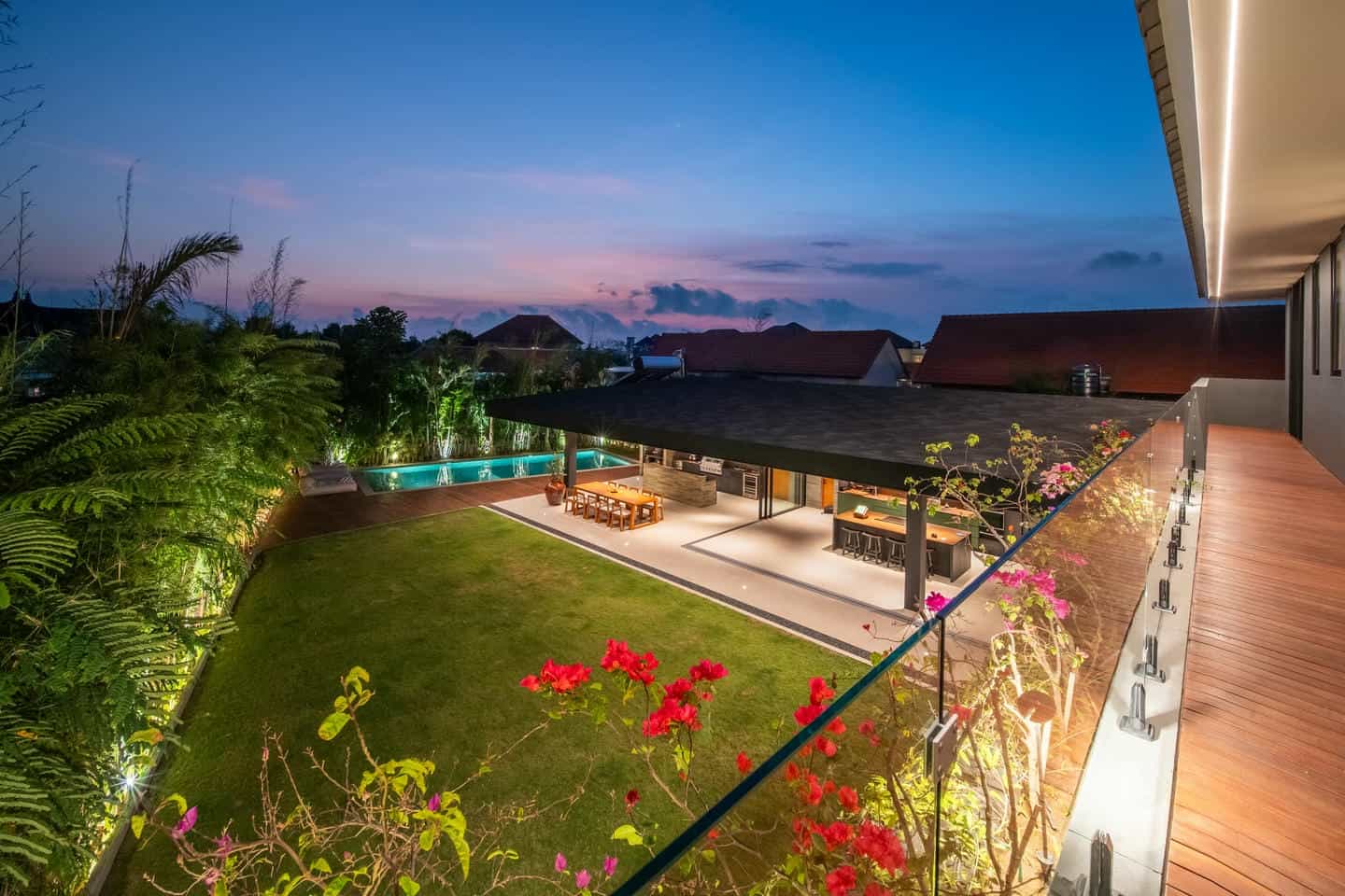 Modern villa with pool at sunset.