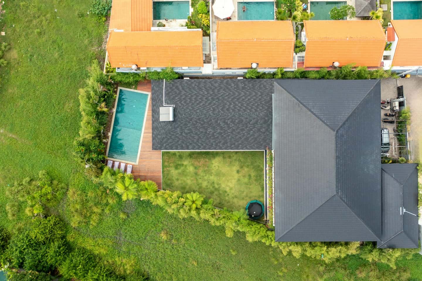 Aerial view of house, pool, and garden.
