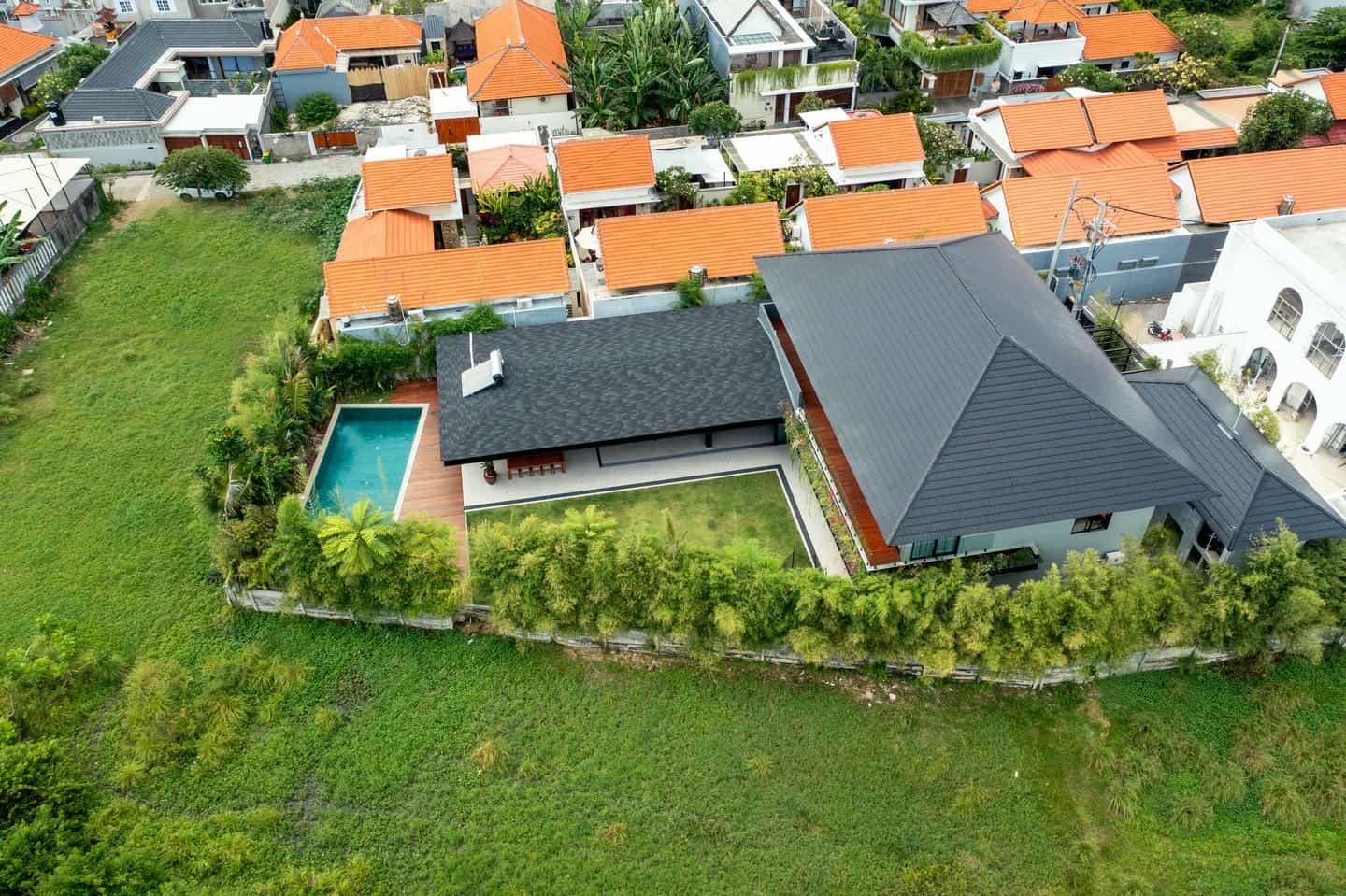 Aerial view of house with pool and garden.