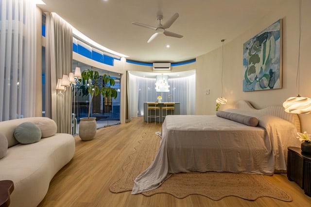 Modern bedroom with large windows and wooden floor.