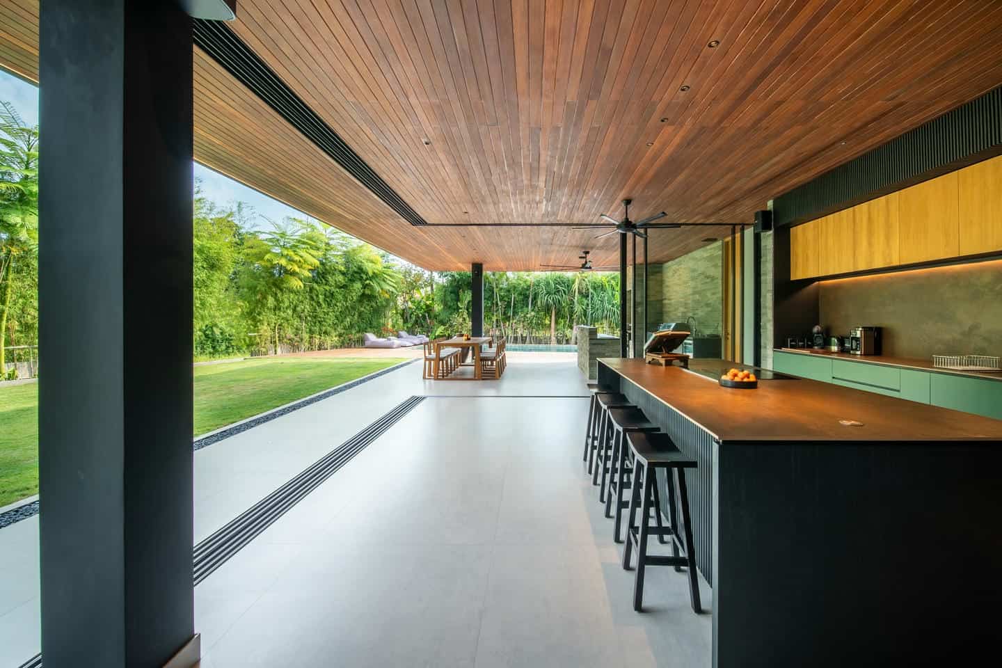 Modern open-air kitchen and dining area view.