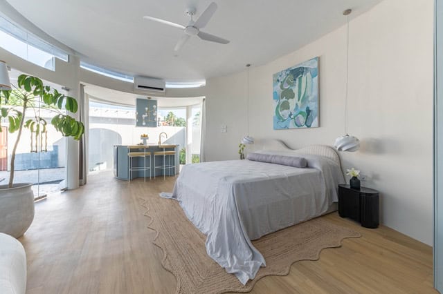Modern bedroom with large windows and artwork