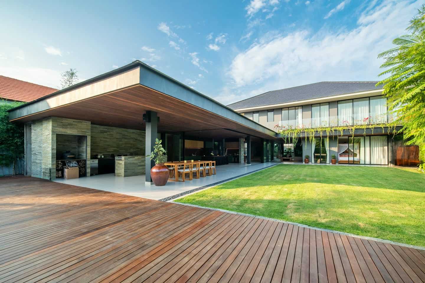 Modern house with spacious outdoor patio and lawn.