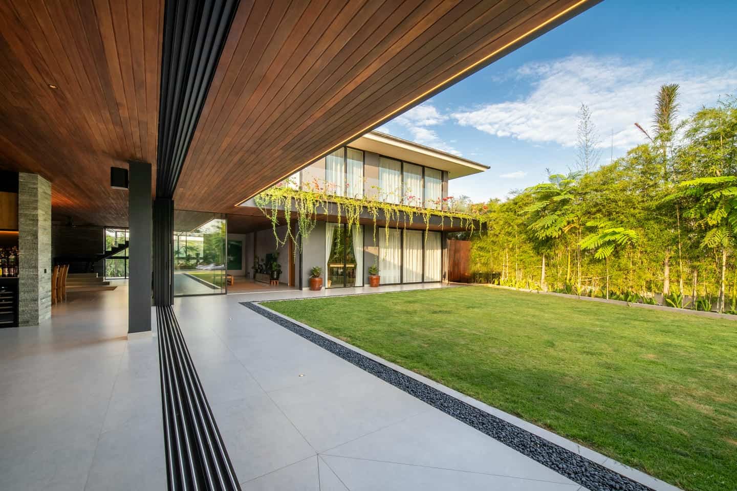 Modern house with spacious garden and glass walls.