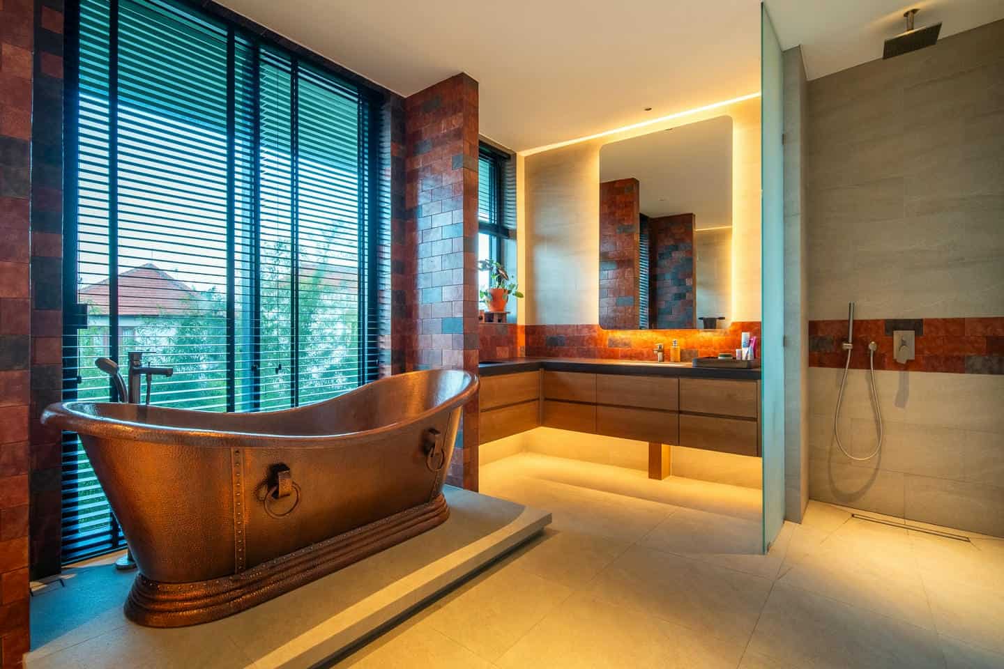 Luxurious bathroom with copper bathtub and modern design.