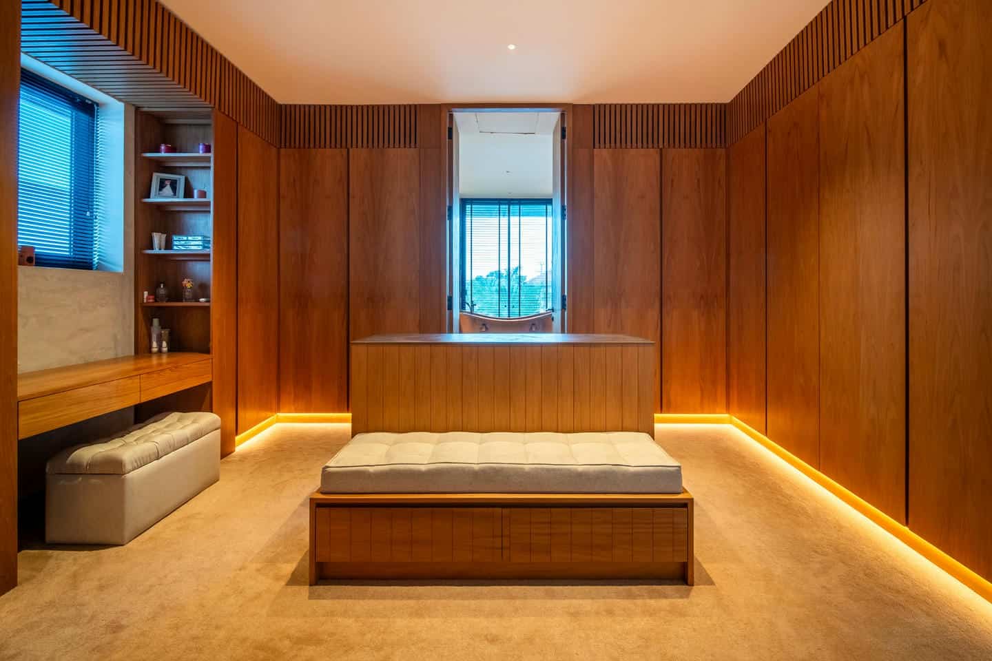 Modern wooden interior with ambient lighting and seating.