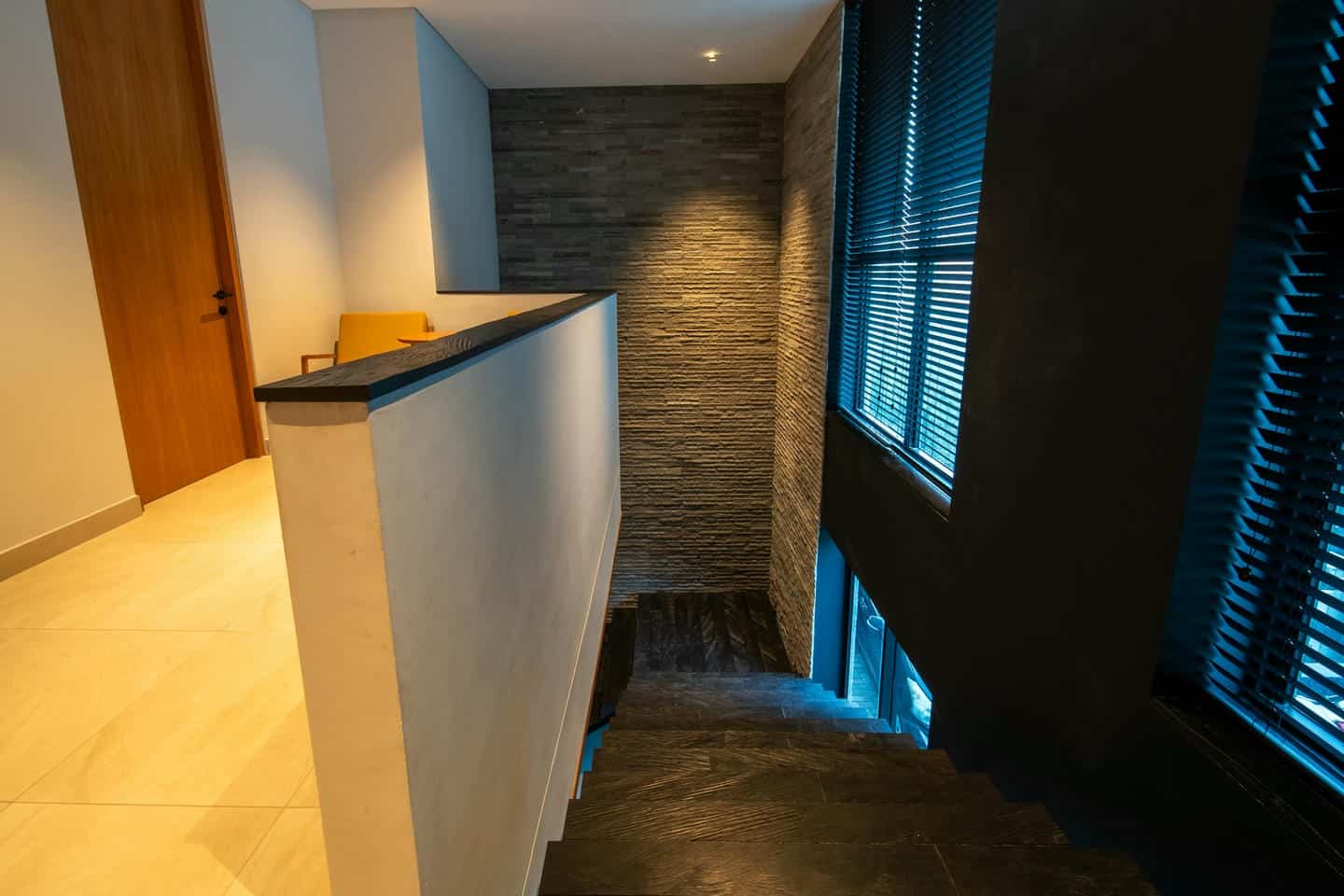 Modern interior staircase with stone walls and window